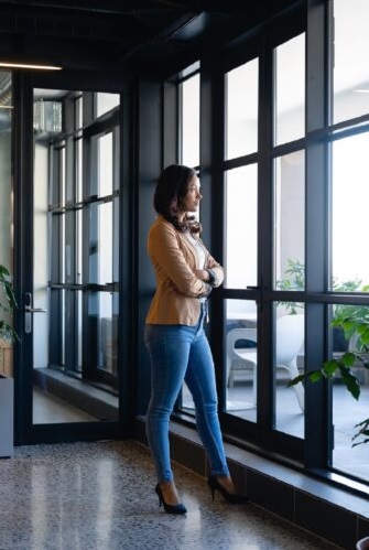 Business professional in a modern office reflecting on strategy
